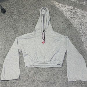 A grey crop top hoodie.